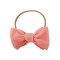 Detailed macro of salmon pink waffle knit bow headband with stretchy elastic band - One Size / Flesh Pink