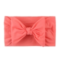Soft coral pink nylon baby headband with a large elastic knit bow for infant girls - Watermelon red