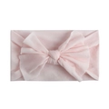 Close-up of soft light pink nylon baby headband with a wide elastic bow detail - Light Pink