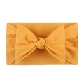 Soft nylon baby headband with large mustard yellow bow made of comfy knitted cotton - Earthy Yellow