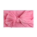 Detail shot of a soft pink nylon baby headband with a single layer knit bow texture - Pink