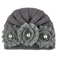 Detail of grey knitted baby turban hat with delicate fabric flowers and pearl accents - One Size / Gray
