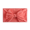 Close-up of soft coral orange nylon headband for babies featuring a layered bow detail - Dark Mauve