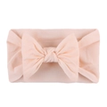 Soft nylon infant headband featuring a large pale pink bow for baby girls - Nude Pink