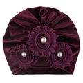 Close-up of burgundy velvet baby turban hat with three fabric flowers and white pearls - Burgundy