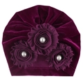 Detail of purple velvet baby turban hat featuring elegant fabric flowers and faux pearls - Fuschia