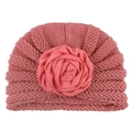 Detail of pink knitted baby turban hat featuring a large satin rose flower decoration - Watermelon red