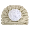 Macro detail of creamy white knitted baby turban hat with a large soft fabric flower - Beige
