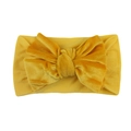 Detailed view of yellow velvet baby headband with a large elastic knotted bow - Yellow