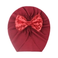 Macro detail of wine red baby turban hat featuring a sparkling red sequined bow accessory - Burgundy