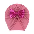 Macro view of a baby turban hat featuring a large pink sequin bow and pleated fabric - Dark Mauve