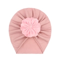 Detail showing soft pink baby turban hat with a large layered fabric flower decoration - Dusky Pink
