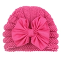 Detailed view of baby girl pink knit hat featuring a large soft fabric bow decoration - Rose Red