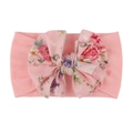 Dettaglio di una fascia per neonati con grande fiocco floreale rosa su nylon morbido - Rosa