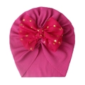 Detail of rose pink ribbed baby beanie featuring a large mesh bow with gold dots - Fuschia