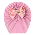 Detail of soft pink baby hat with large floral bow print and fine knit texture - Pink