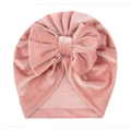 Pink velvet baby turban hat with a large bow decoration on white background - One Size / Dusky Pink