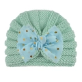 Detailed close-up of mint green knitted baby turban hat with a blue polka dot bow - Mint Green