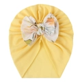 Detail of yellow baby turban hat with a large floral bow on soft elastic fabric - Off White