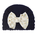 Detail of baby knit hat in navy blue featuring a large white sequin bow decoration - Navy Blue