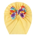 Detailed view of yellow baby turban hat with a large colorful floral print bow accent - Beige