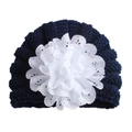 Knitted dark blue baby hat featuring a large white lace flower decoration on the front - Adjustable / Navy Blue