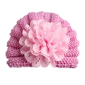 Detailed close-up of pink knit baby hat featuring a large delicate lace flower decoration - Adjustable / Pink