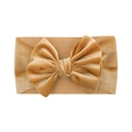 Detailed close-up of a mustard yellow velvet baby headband with a large handmade bow - Yellow