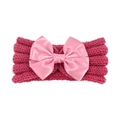 Close-up of baby knitted headband with pink satin bow in deep magenta cable knit texture - Dusky Pink
