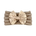 Detail of baby knitted headband with large champagne satin bow and ribbed texture - Beige