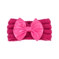 Detailed view of the rose red knitted baby headband featuring a large satin bow accent - Rose Red