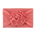 Soft nylon infant headband featuring a large coral pink handmade rose flower decoration - Watermelon red