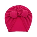 Detailed close-up of hot pink baby turban hat with a large decorative bow on white background - One Size / Rose Red