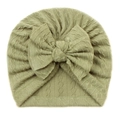 Knitted infant turban hat in soft light bean green featuring a large decorative bow - Green