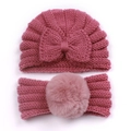 Detail of baby knitted bow hat and faux fur pompom headband in dusty pink color - Dusky Pink