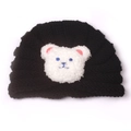 Close-up of black knitted baby hat featuring a white plush bear patch with pink inner ears - Black