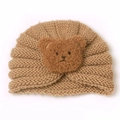 Knitted baby winter hat featuring cute plush bear character on cozy earflap beanie - Coffee