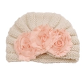 Detailed knit texture and pink fabric flowers on a beige baby turban hat - Beige