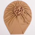 Detail of baby turban hat featuring pleated knit fabric and a large satin rose decoration - Coffee