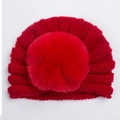 Detail van een rode gebreide tulbandmuts voor baby's met een zachte faux fur pompon - Rood