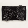 Close-up of black nylon headband with a large silver speckled mesh bow for babies - Black