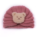 Knitted baby winter hat in dusty pink featuring a cute plush bear patch on the front - Dusky Pink