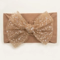 Close-up of soft tan nylon baby headband featuring a sparkling sequin mesh bow detail - Coffee