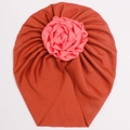 Ribbed brick red baby turban hat featuring a delicate pink fabric flower decoration - Wine Red