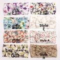 Detailed flat lay of eight soft baby headbands with various floral patterns and styles - Mixed 8 Colors
