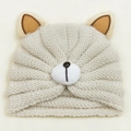 Detailed macro view of soft cream knit baby bear hat with cute 3D ears and plush nose - Beige