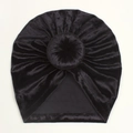 Detailed top view of a black velvet baby turban hat with a stylish donut knot decoration - Black