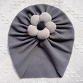 Detailed waffle knit texture of dark grey baby turban hat with a large 3D fabric flower - Gray