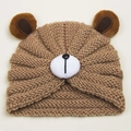 Detailed close-up of brown knitted baby bear hat with 3D ears and cute animal design - Coffee