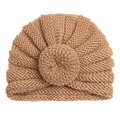 Detail of baby turban hat showing thick vertical knit texture and round doughnut ball - Coffee